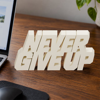 Never Give Up desk letters on an office desk
