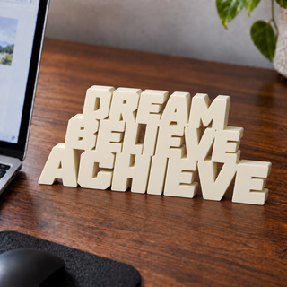 Dream Believe Achieve desk letters on an office desk