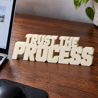 Trust the Process desk letters on an office desk