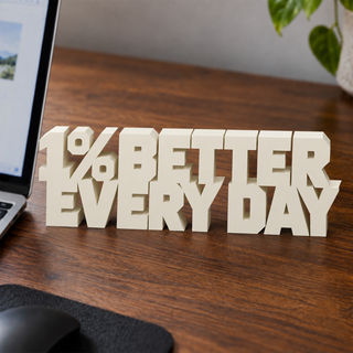 1% Better Every Day desk letters on an office desk
