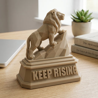 Keep Rising (Lion) desk trophy on a home office desk