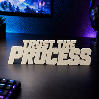 Trust the Process desk letters on a gaming desk