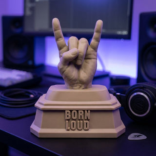 Born Loud (Rock Hand) desk trophy on an executive desk