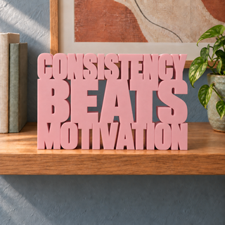 Consistency Beats Motivation desk letters in Sakura Pink