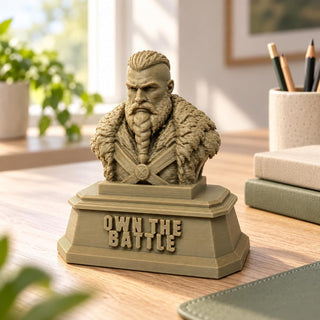 The Warrior Sandstorm desk sculpture with OWN THE BATTLE plinth on a wooden desk