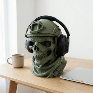 Skull headphone stand as home office desk decor beside a laptop and coffee mug
