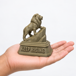 Regular The Lion desk sculpture held in a palm for scale