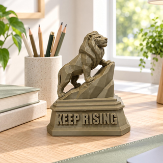 Regular The Lion sculpture on an office desk beside books and pencils