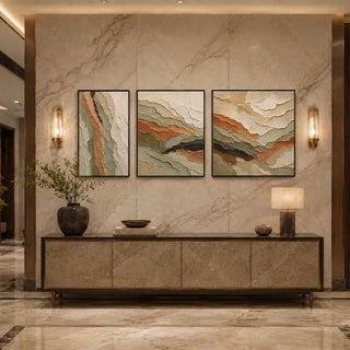 Black box framed relief canvas triptych above a marble console