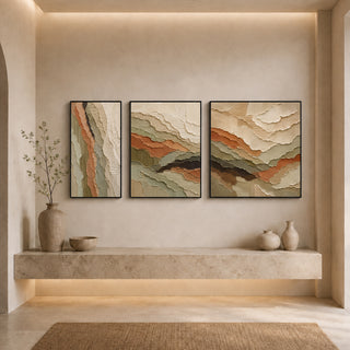 Black box framed relief canvas set of 3 above a stone ledge