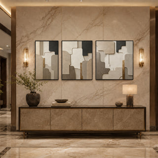 Black box framed stone relief triptych above a marble console