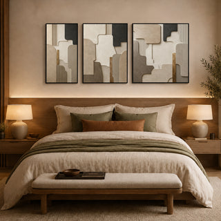 Framed stone relief wall art above a bed in a warm bedroom