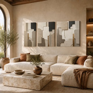 Sculpted stone 3D relief textured canvas set of 3 above a cream sofa