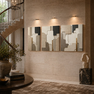 Carved stone relief canvas triptych on a stairwell wall
