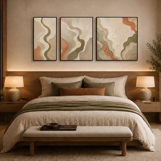 Framed flowing relief wall art above a bed in a warm bedroom