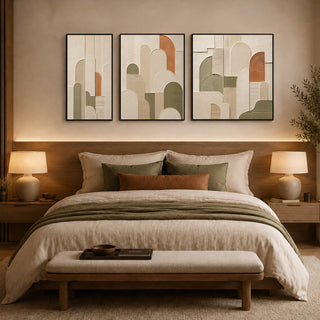 Framed abstract relief wall art above a bed in a warm bedroom