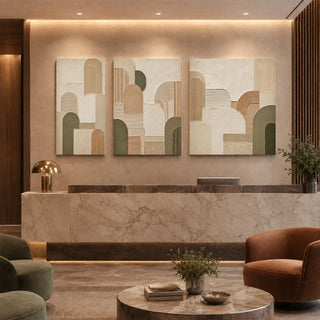 Geometric abstract relief canvas set of 3 in a marble reception lobby