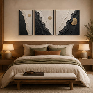 Framed abstract relief wall art above a bed in a warm bedroom
