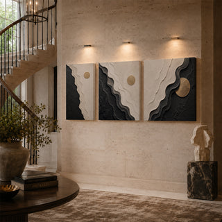 Black and white abstract relief canvas triptych on a stairwell wall