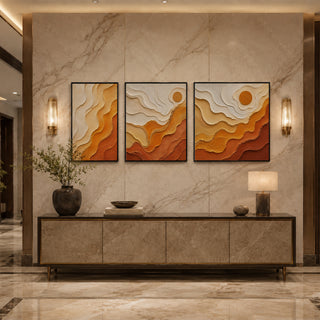 Black box framed amber abstract relief triptych above a marble console