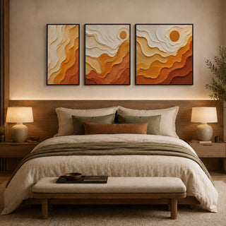 Framed abstract relief wall art above a bed in a warm bedroom