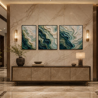 Black box framed teal abstract relief triptych above a marble console
