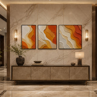 Black box framed saffron abstract relief triptych above a marble console