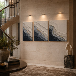 Grey abstract relief canvas triptych on a stairwell wall