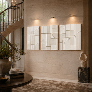 Ivory geometric abstract relief canvas triptych on a stairwell wall