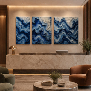 Cobalt blue abstract relief canvas set of 3 in a marble reception lobby