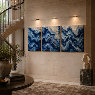 Cobalt blue abstract relief canvas triptych on a stairwell wall