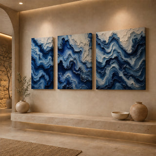 Gallery wrap cobalt blue abstract relief canvas above a stone ledge