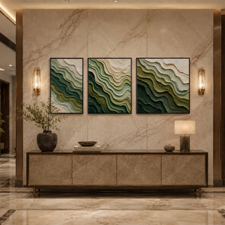 Black box framed green abstract relief triptych above a marble console