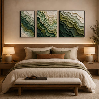 Framed abstract relief wall art above a bed in a warm bedroom