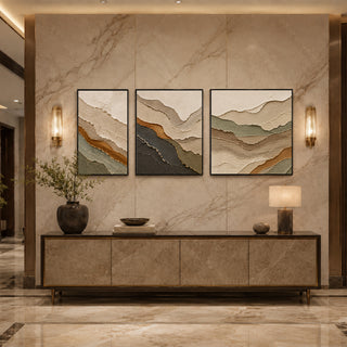 Black box framed cream and charcoal ridge abstract relief triptych above a marble console